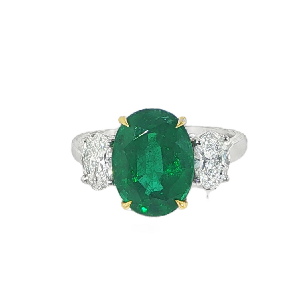 Platinum Three Stone Ring Featuring An Oval Cut Emerald Center Stone - Size 6.25